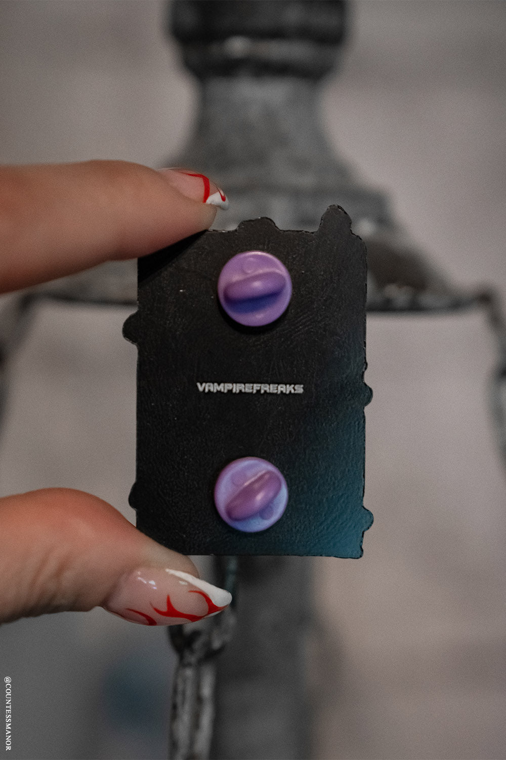 engraved goth enamel pin with vampirefreaks branding on the back