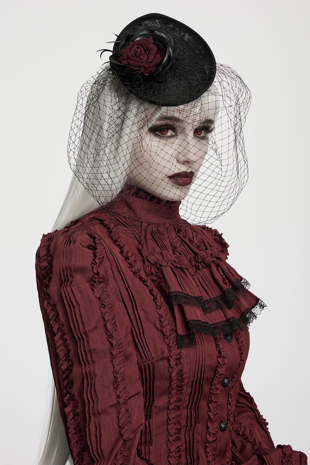 black hat with red rose and black feathers veil