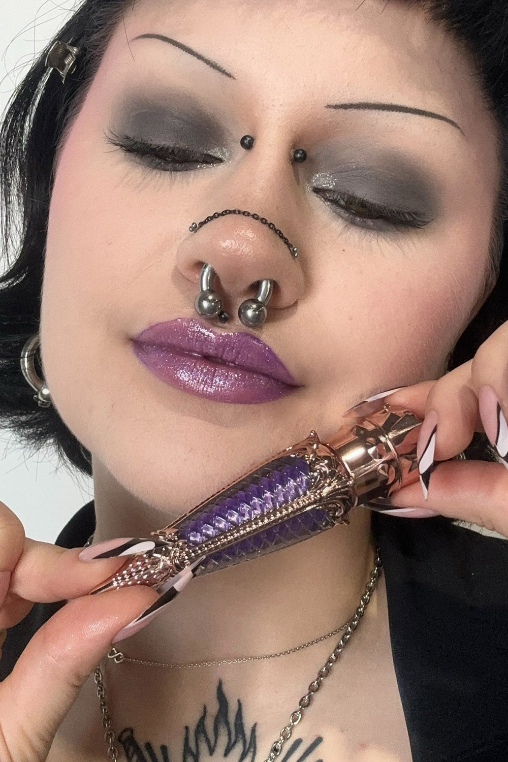 goth woman wearing purple makeup