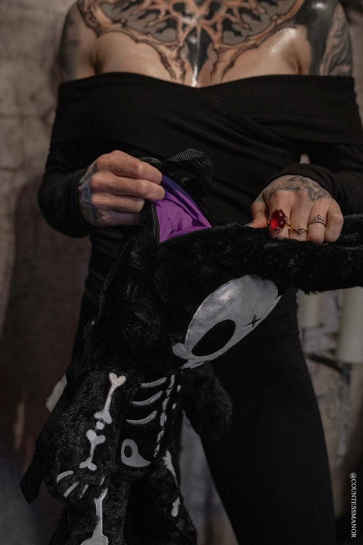 creepy plushie backpack with purple interior lining 