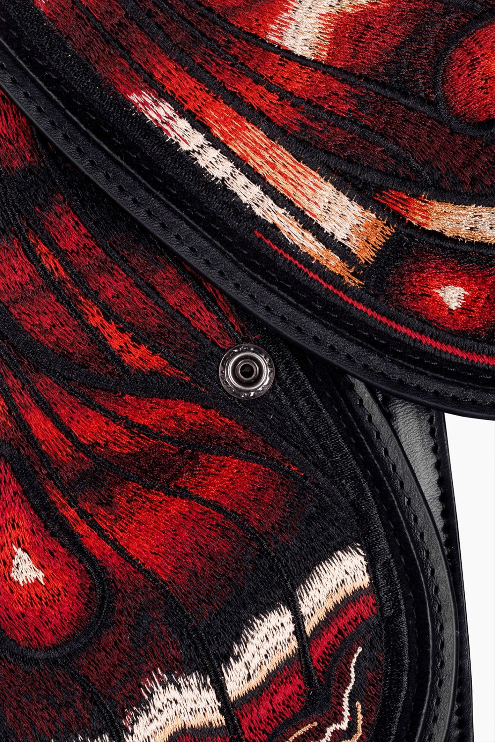 Close up detail of crimson moth backpack wings