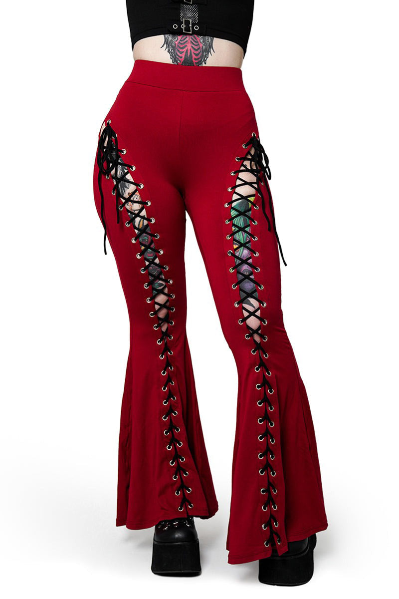 Red flared pants with black lace-up details on a white background