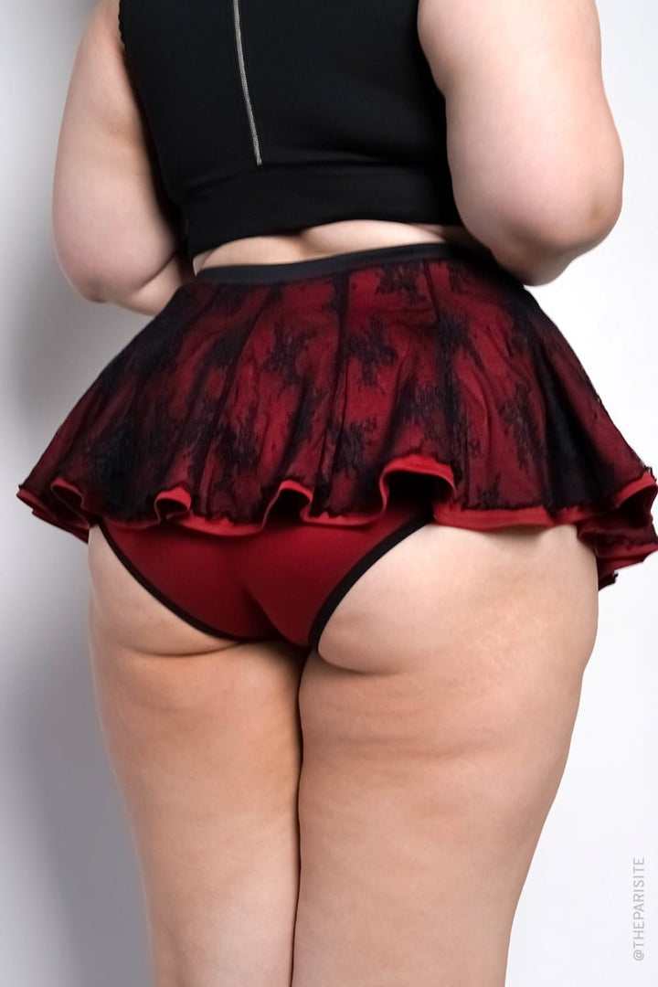 red swim skirt with black lace overlay and  attached bikini bottoms