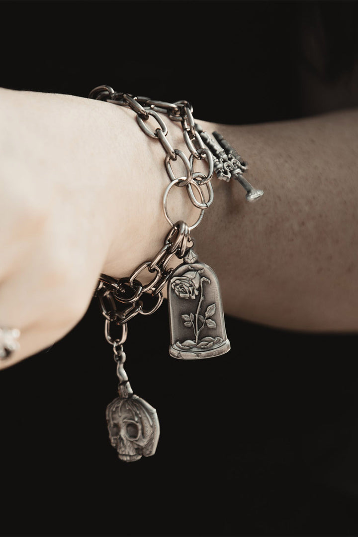 dark academia bracelet  with candle, rose, and skull charms 