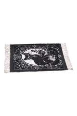 Small black and white cotton rug with cat and tassels