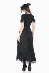 Back view of model wearing black top with lace short sleeves