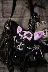 dark whimsical spooky embroidered stuffed animal purple and black skeleton bat keychain bag charm on a gothic purse