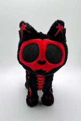 Black and red Skeleton kitty cat plush toy on a white background