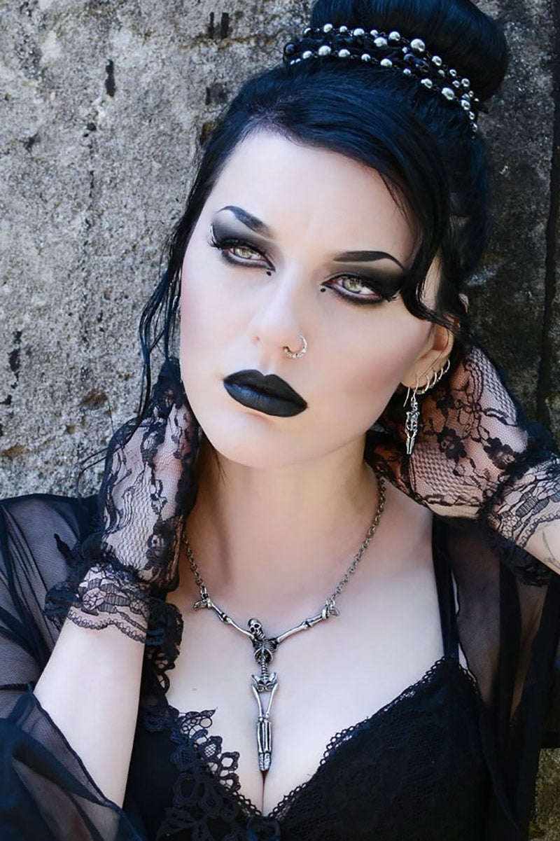 gothic woman wearing a skeleton pirate necklace