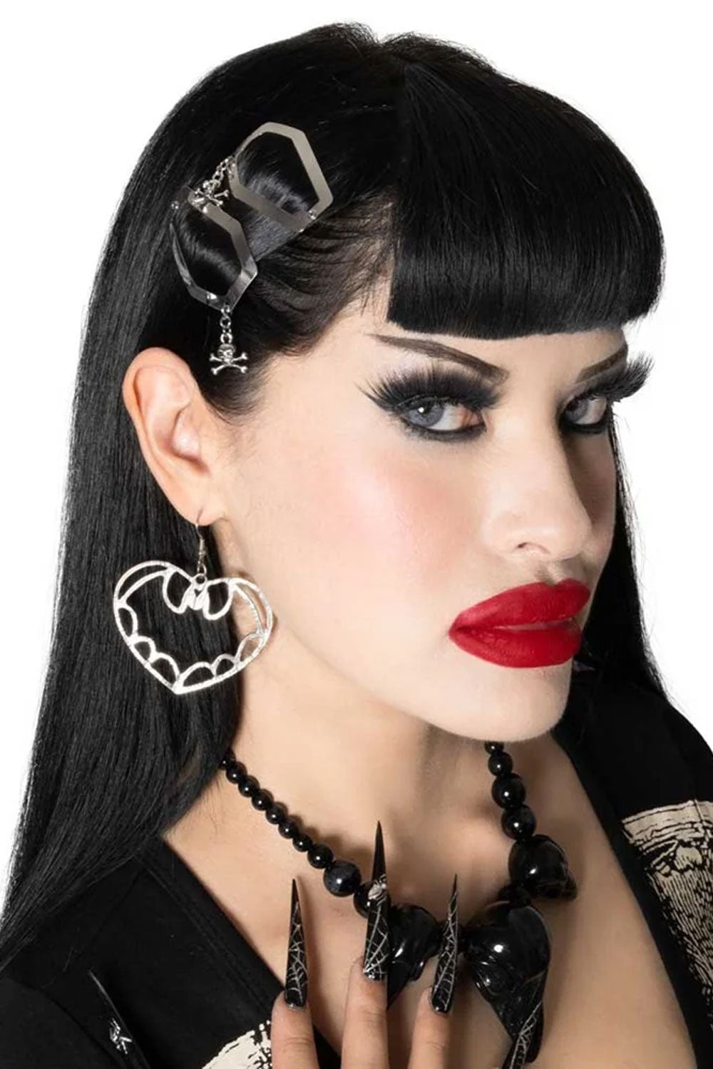 coffin-shaped hair clip features a spooky skull and crossbones charm for an extra touch of gothic flair