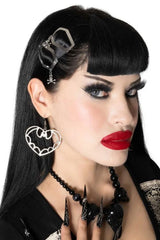 coffin-shaped hair clip features a spooky skull and crossbones charm for an extra touch of gothic flair