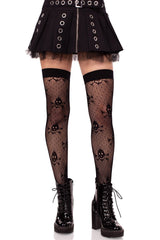 Person wearing black fishnet stockings with skull designs, a black skirt, and black boots on a white background.