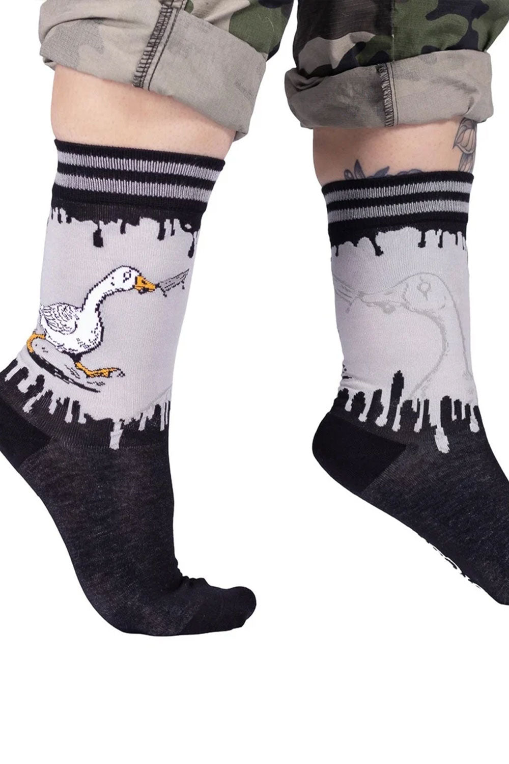 black gray socks with white goose carrying knife