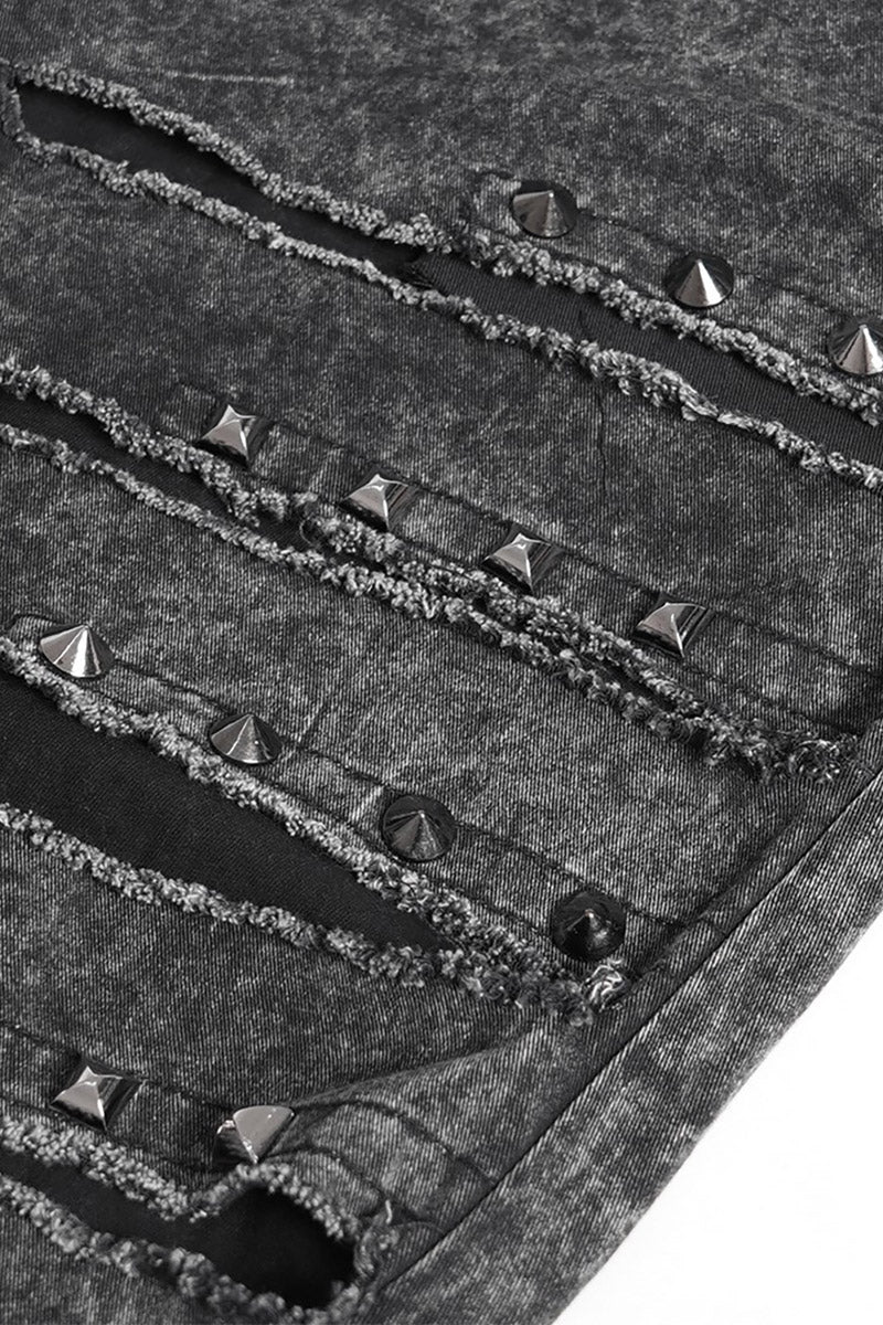 Close-up of a textured goth pant with metallic studs and rivets.