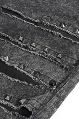 Close-up of a textured goth pant with metallic studs and rivets.