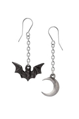 Bat and moon earrings on a white background
