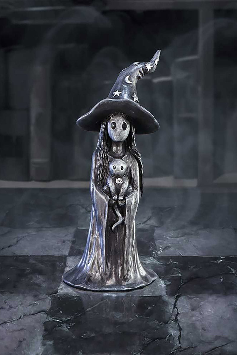 statue of witch holding a cat