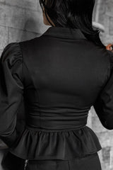 gothic woman wearing a black collared vampire goth long sleeve victorian top with flared sleeve cuffs