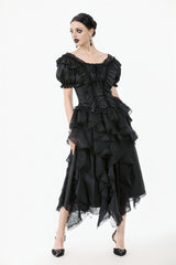 Black ruffled dress worn by a model on a white background