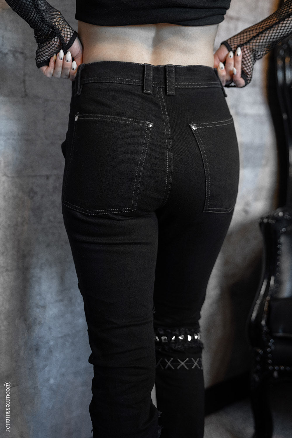 studded shredded distressed emo skinny jeans made of black denim 