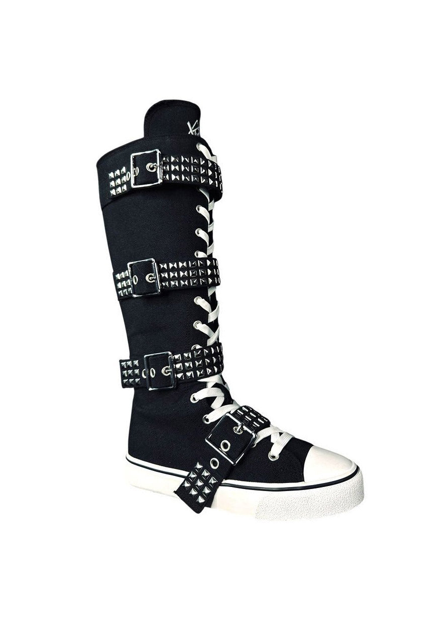 Black high-top sneaker with white laces and studded details on a white background