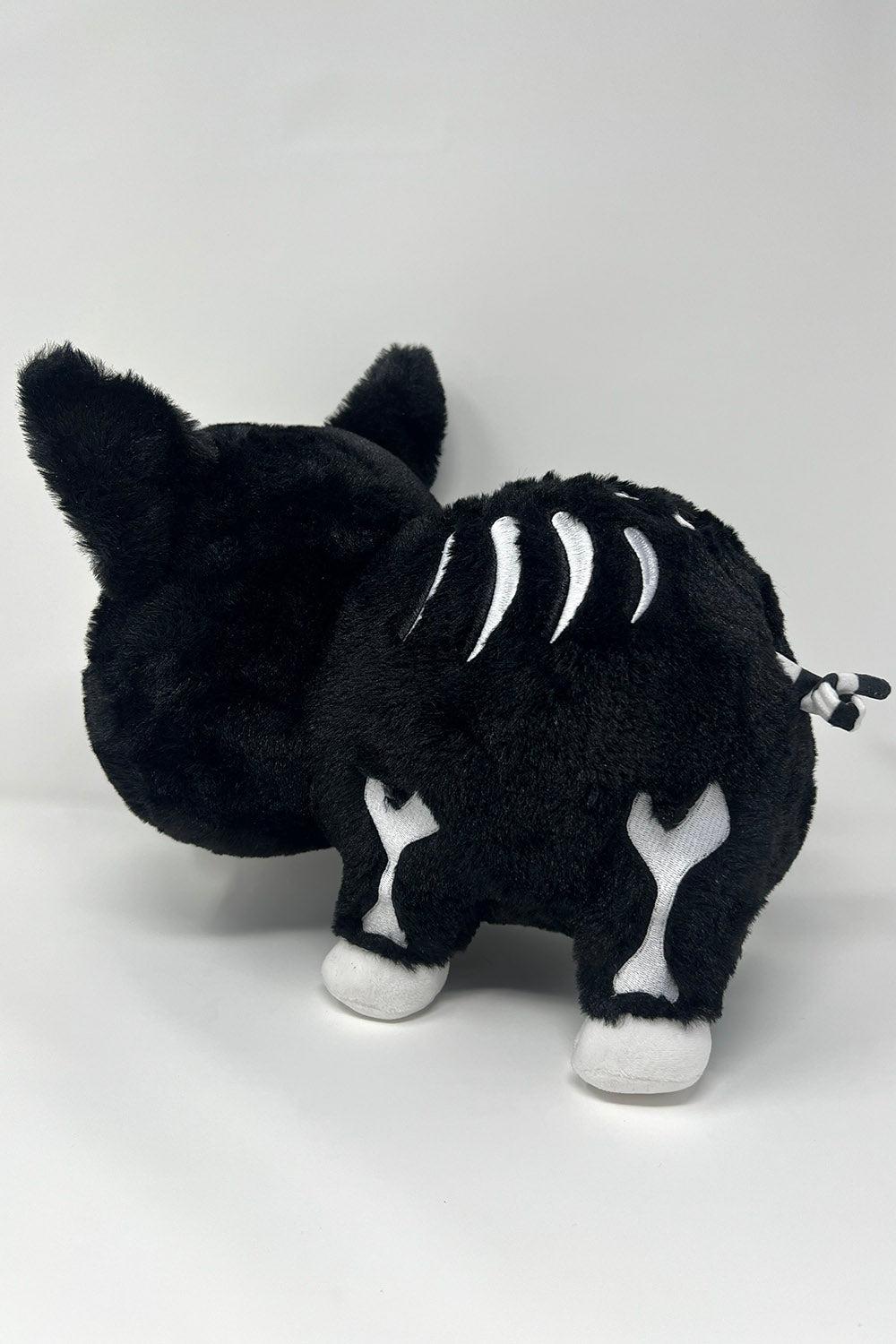 embroidered black and white stuffed animal skeleton plushie with spiral tail
