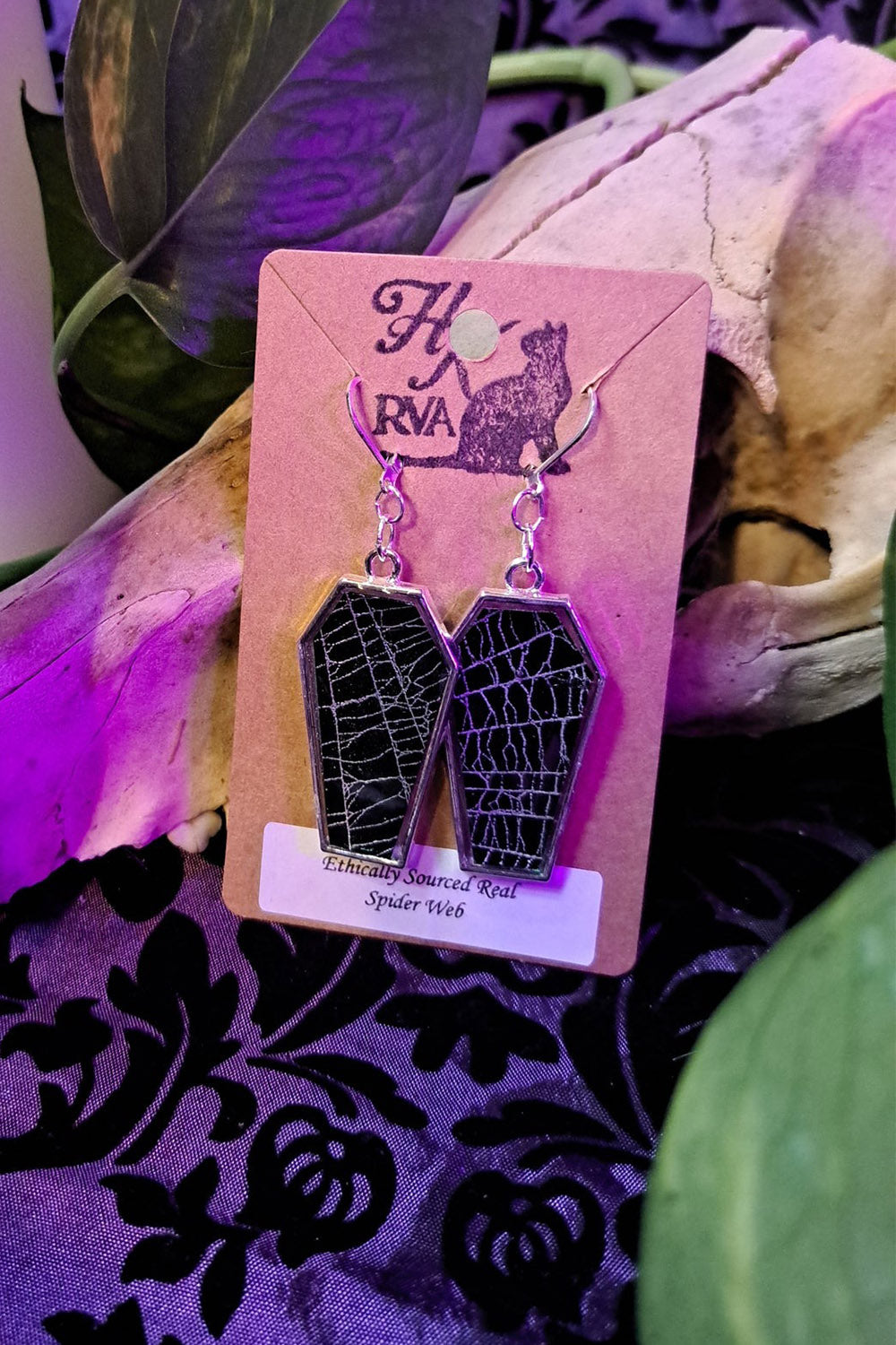 coffin shaped earrings with real preserved spiderwebs in them 