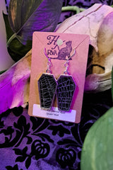coffin shaped earrings with real preserved spiderwebs in them 