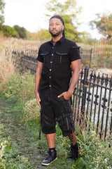 Mens black alternative fashion shirt with metal buckle shoulder details and functional front pockets for goth punk and edgy streetwear outfits