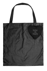 Black tote bag with a heart-shaped keychain made of velvet reading 'babe in black' on a white background