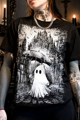 black tshirt with white printed artwork of ghost holding an umbrella walking in front of a castle in the rain