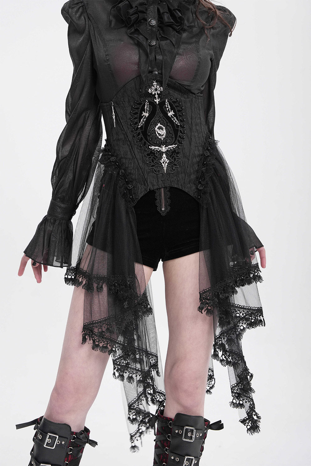 Person wearing a black gothic outfit with lace details on a white background