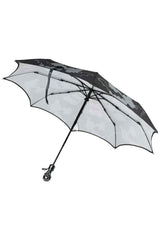 Black and white striped anti UV umbrella with skull shaped handle for gothic horror fashion and dark alternative style