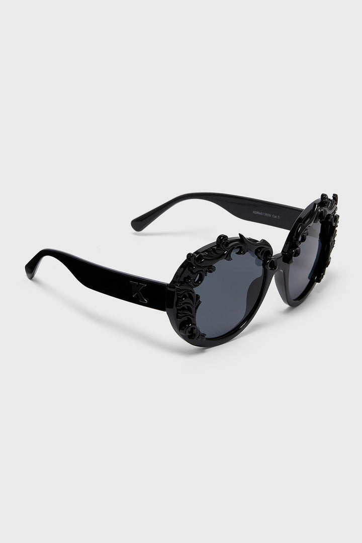 Black sunglasses with decorative details on a white background