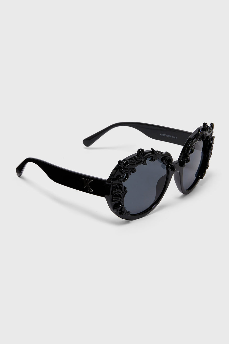 Black sunglasses with decorative details on a white background