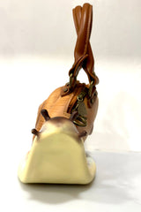 snail handbag with a brown handle on a white background