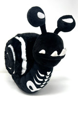 Black and white plush toy resembling a snail on a white background