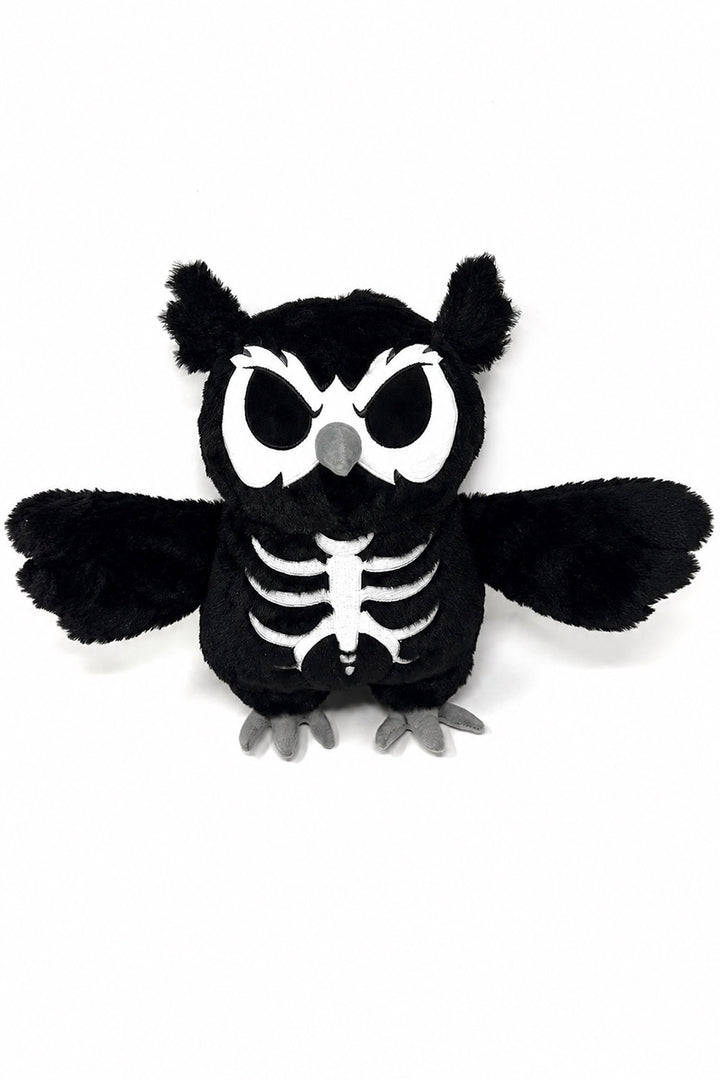 A black plush owl toy with a white skeleton print on its chest, large white eyes, and gray beak and feet, shown against a plain white background.