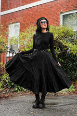 gothic woman wearing a tiered long skirt