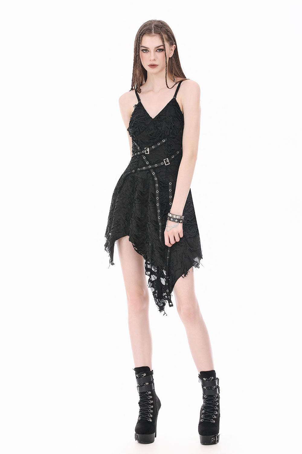 Model wearing punk dress in black with irregular hem and rivet details