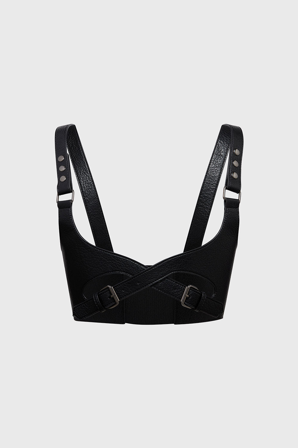 Black leather harness with straps on a light gray background