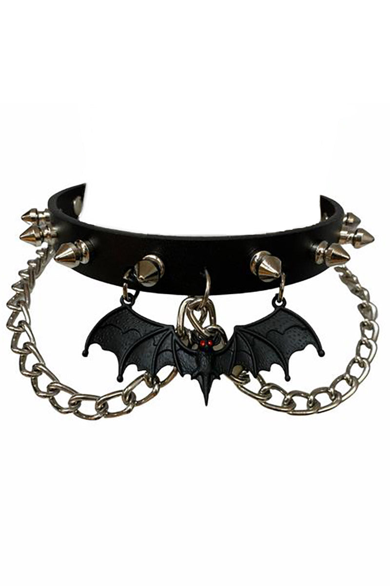 A black leather choker necklace with metal rivet spikes, chains, and a bat charm with red rhinestones.