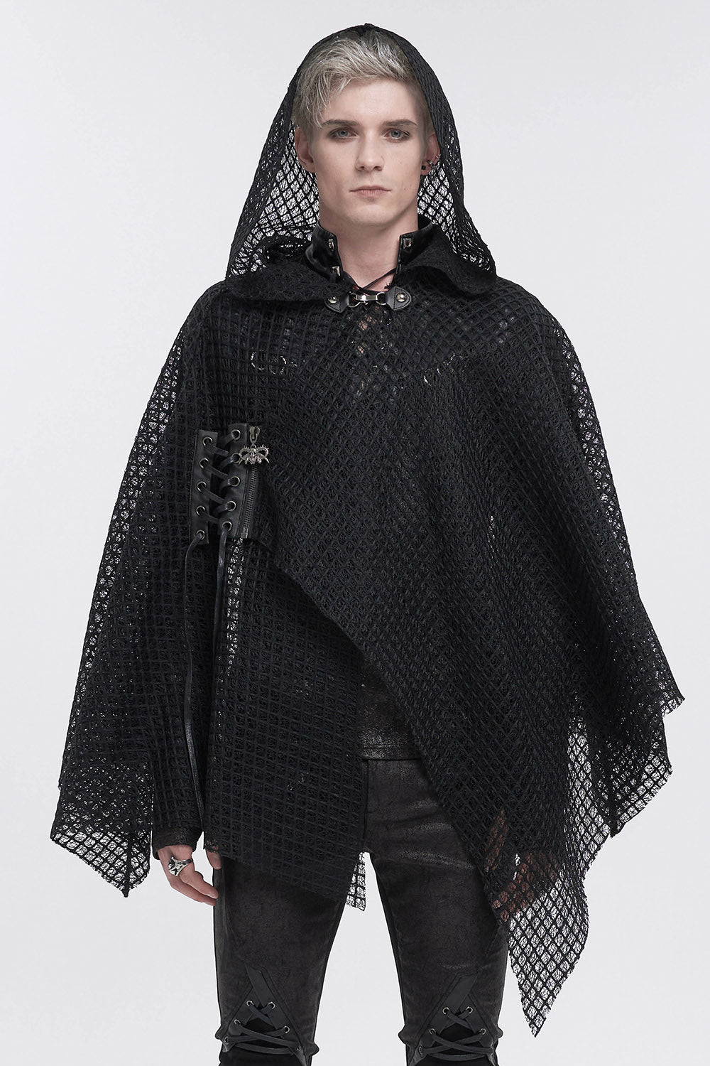 Person wearing a black hooded garment with intricate detailing on a white background