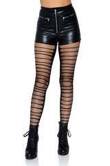 A pair of black fishnet tights with shredded details down the front, worn with high-waisted shorts and black boots.