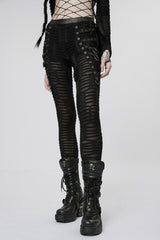 Person wearing black distressed leggings pants and boots on a white background